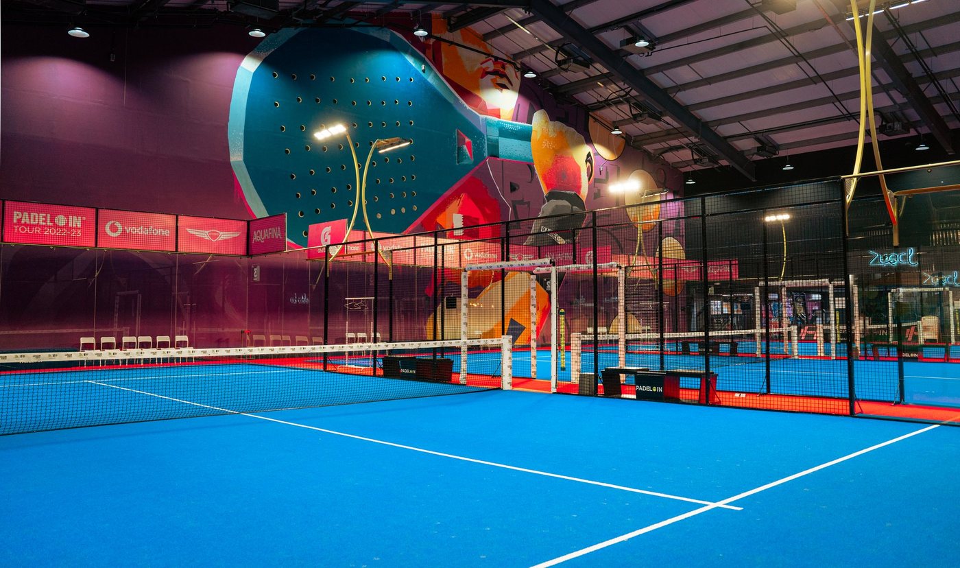 A Padel IN indoor court beneath the mural wall